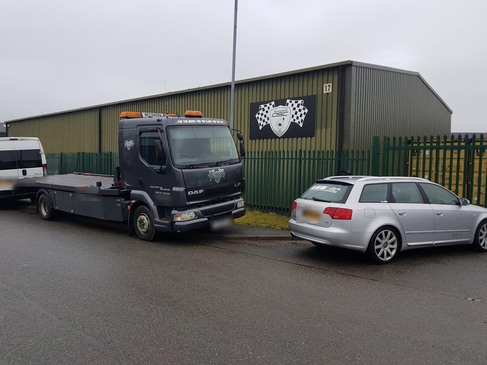 The DSC unit on Millbuck Way with the chequered-flag shield sign, the DSC liveried DAF recovery truck and a silver Audi estate